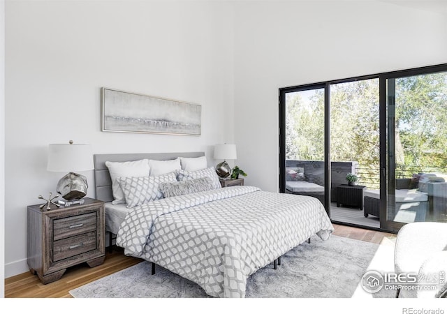 bedroom with hardwood / wood-style flooring and access to exterior