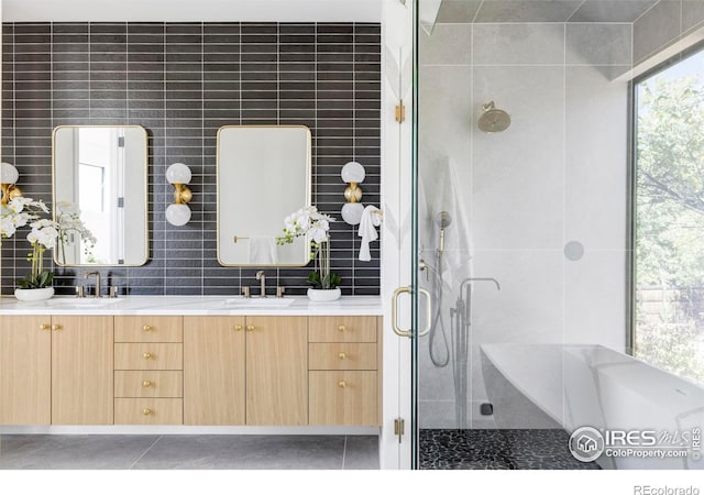 bathroom featuring tile patterned floors, tile walls, vanity, and shower with separate bathtub