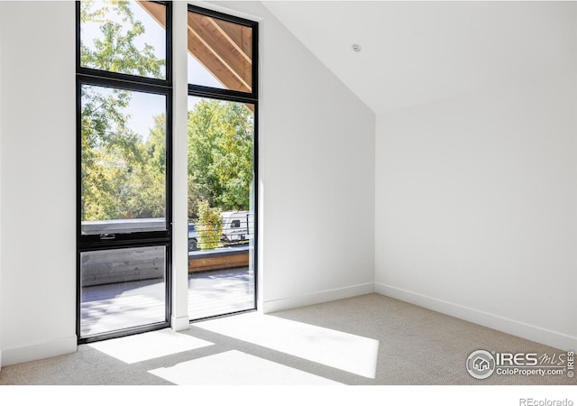 interior space featuring vaulted ceiling and light colored carpet