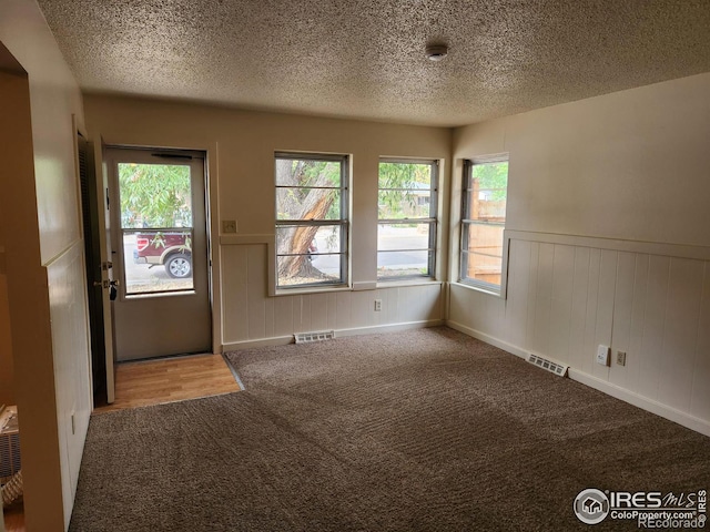 interior space with carpet floors and a textured ceiling