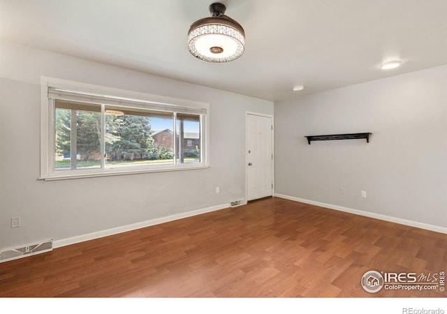 unfurnished room featuring wood-type flooring