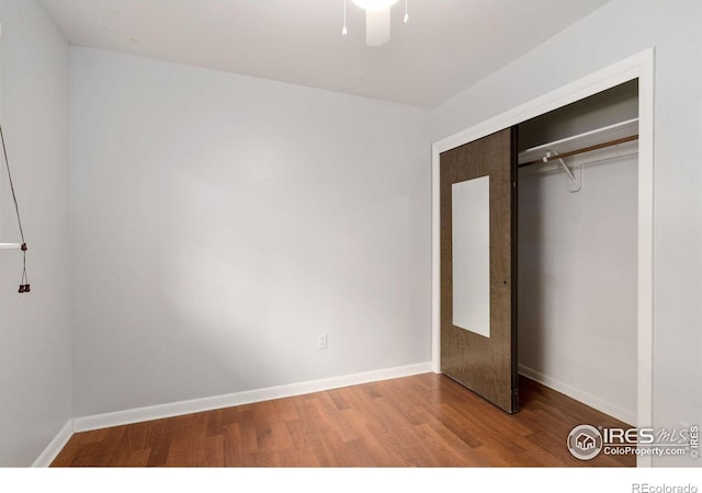 unfurnished bedroom with wood-type flooring and a closet