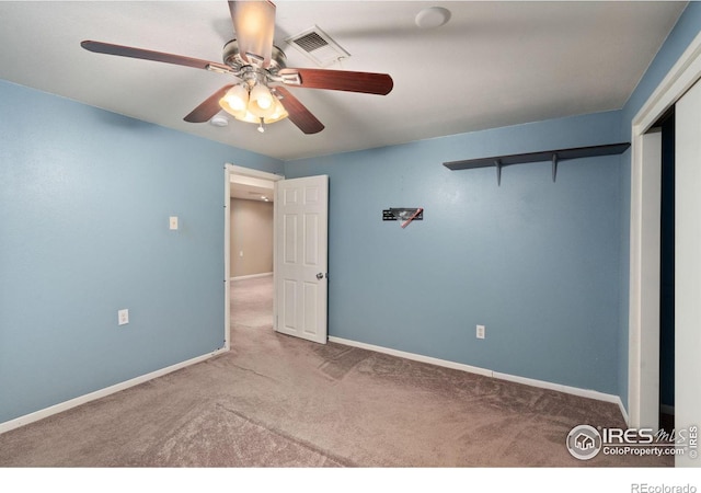 unfurnished bedroom featuring ceiling fan, a closet, and light colored carpet