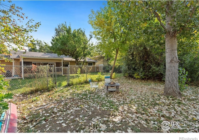 view of yard with a fire pit