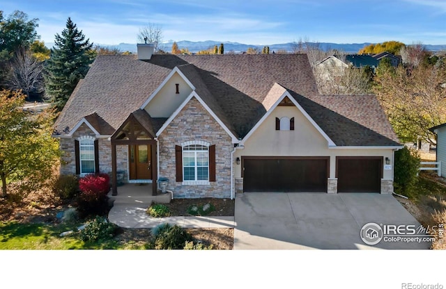 view of front of home featuring a mountain view and a garage