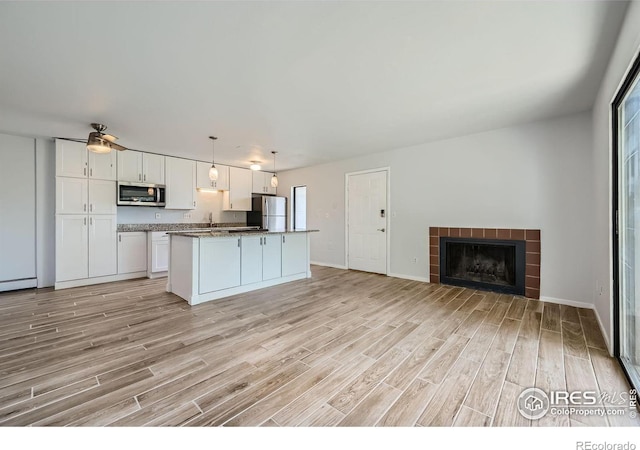 kitchen featuring white cabinetry, appliances with stainless steel finishes, and light hardwood / wood-style flooring