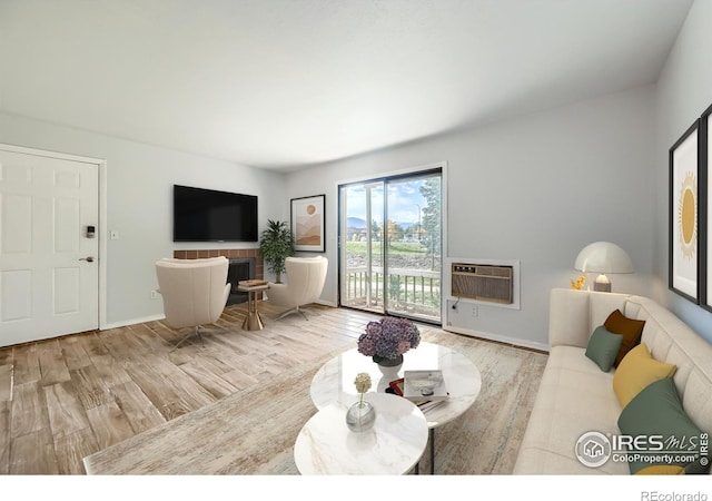 living room featuring a wall unit AC and light wood-type flooring