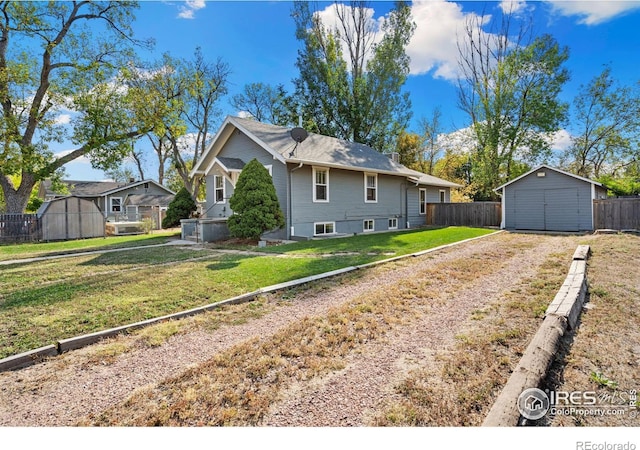 view of front of home featuring a front lawn and a shed