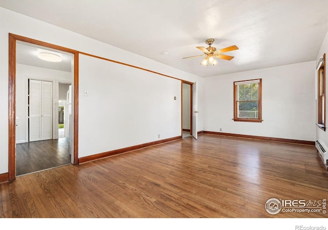 empty room featuring ceiling fan and dark hardwood / wood-style floors