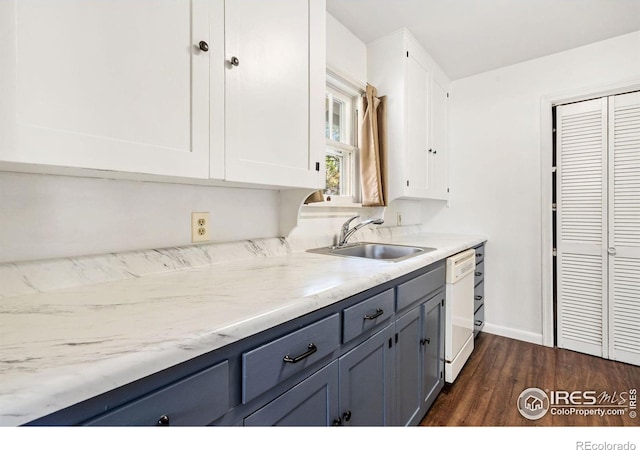 kitchen featuring light stone counters, white dishwasher, sink, white cabinetry, and dark hardwood / wood-style floors