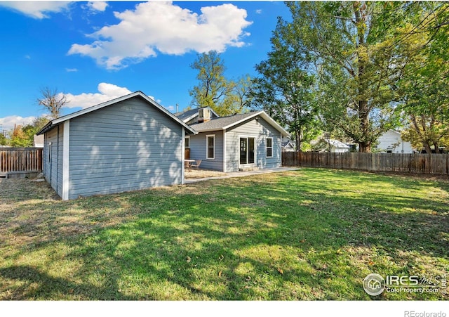 back of house with a lawn