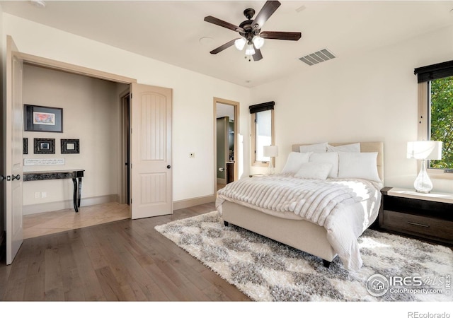 bedroom with ceiling fan and dark wood-type flooring