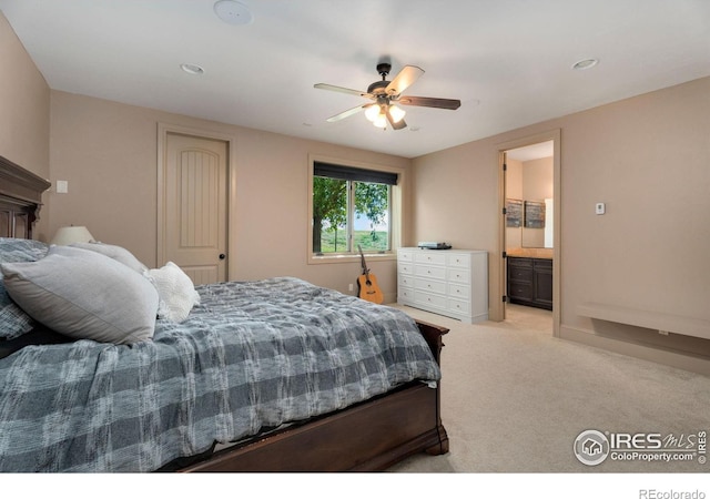 carpeted bedroom with ceiling fan and ensuite bath