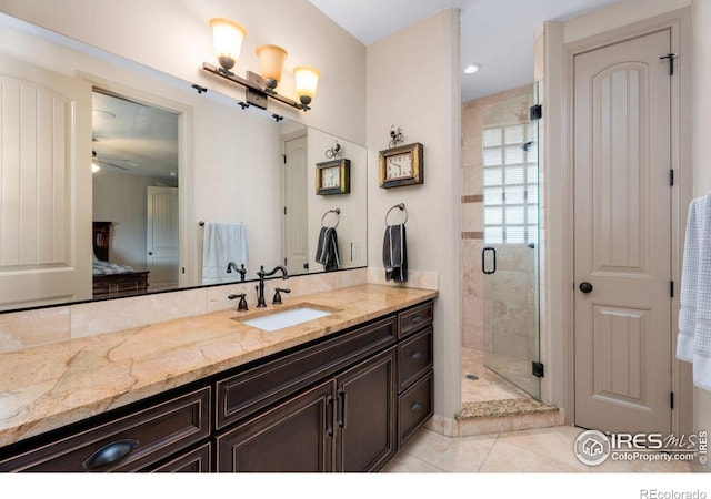 bathroom with ceiling fan, an enclosed shower, tile patterned flooring, and vanity