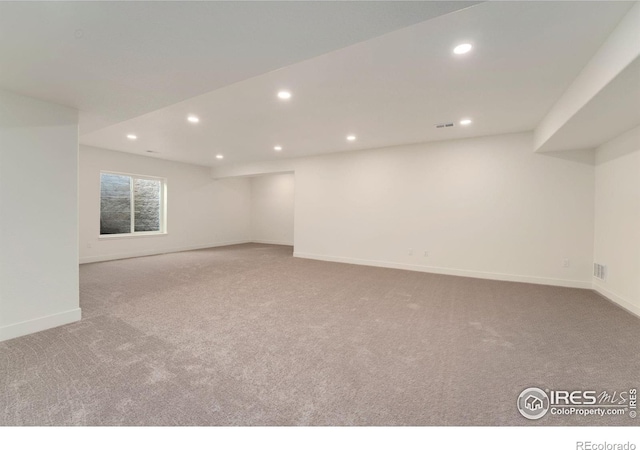 carpeted empty room with visible vents, recessed lighting, and baseboards