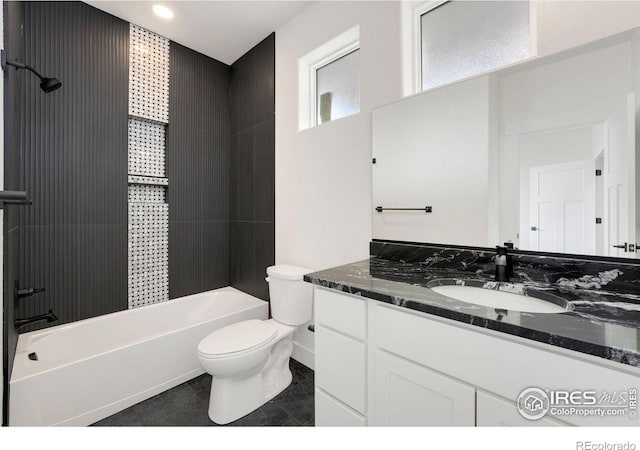 bathroom featuring toilet, vanity, and  shower combination