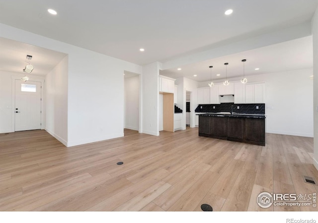 kitchen featuring light wood finished floors, visible vents, tasteful backsplash, recessed lighting, and white cabinetry