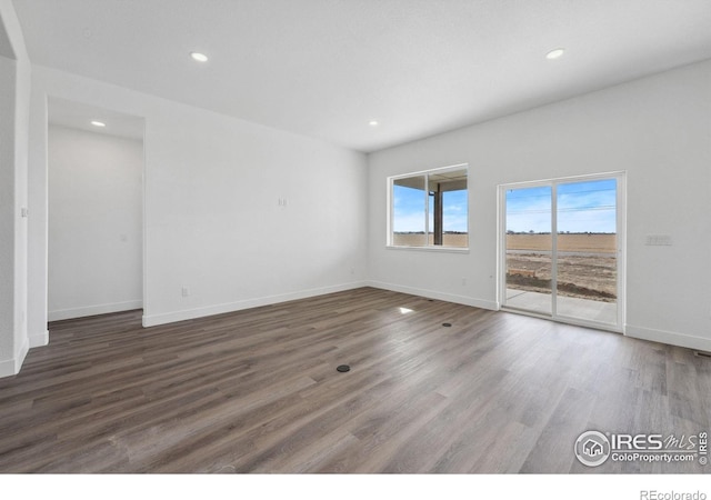 448 Cache Ave, Fort Morgan, CO 80701 - spare room featuring baseboards, wood finished floors, and recessed lighting