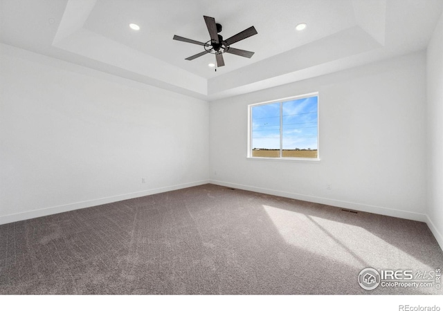 448 Cache Ave, Fort Morgan, CO 80701 - carpeted spare room featuring a tray ceiling, baseboards, and recessed lighting