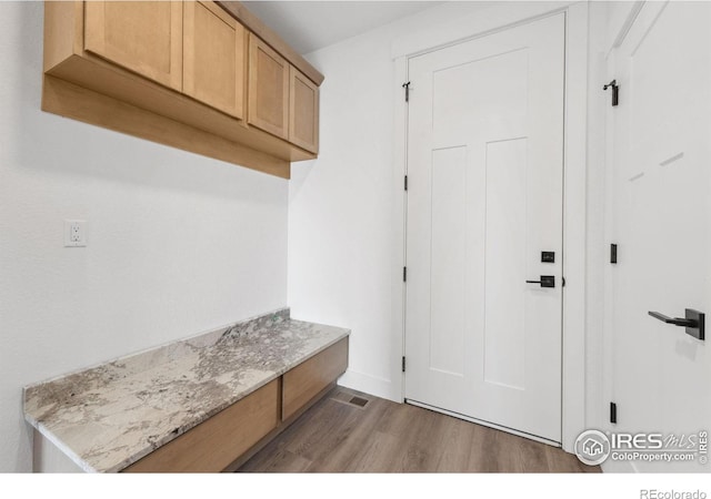 448 Cache Ave, Fort Morgan, CO 80701 - mudroom with visible vents, baseboards, and wood finished floors
