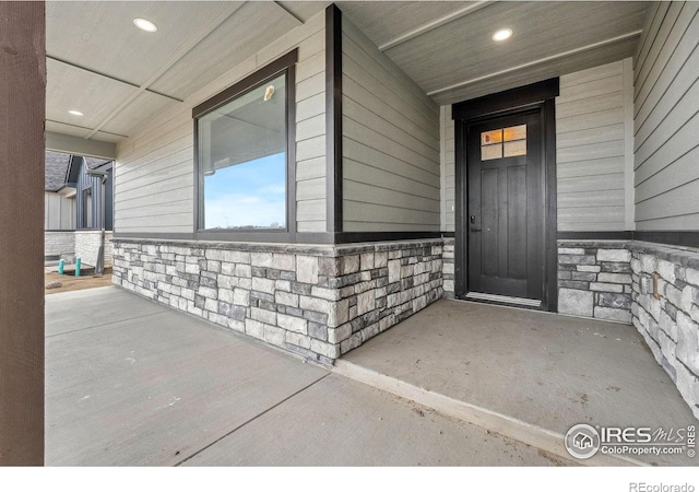 448 Cache Ave, Fort Morgan, CO 80701 - view of exterior entry featuring stone siding