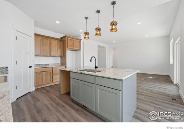 448 Cache Ave, Fort Morgan, CO 80701 - kitchen with recessed lighting, dark wood-style flooring, a sink, light stone counters, and pendant lighting