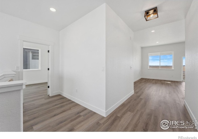 448 Cache Ave, Fort Morgan, CO 80701 - corridor featuring baseboards, wood finished floors, and recessed lighting
