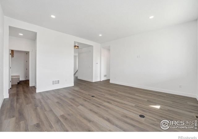 448 Cache Ave, Fort Morgan, CO 80701 - empty room with baseboards, visible vents, recessed lighting, and wood finished floors