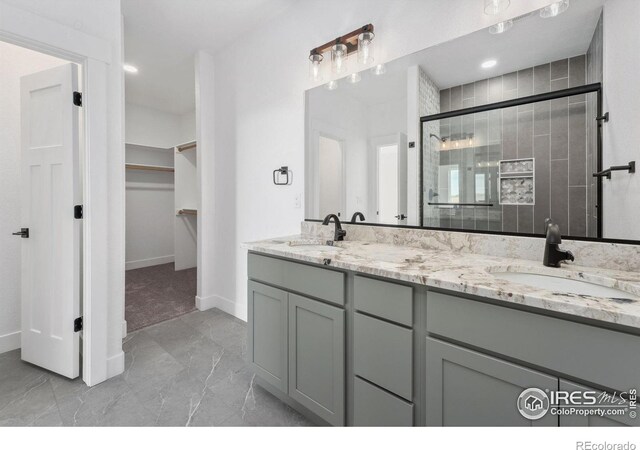 448 Cache Ave, Fort Morgan, CO 80701 - bathroom with marble finish floor, a sink, a walk in closet, and a stall shower