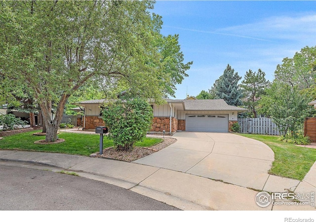 ranch-style home featuring a garage and a front yard