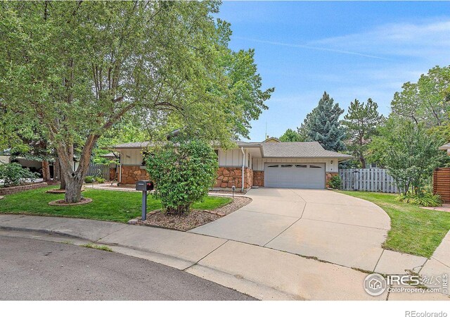 ranch-style home featuring a garage and a front yard