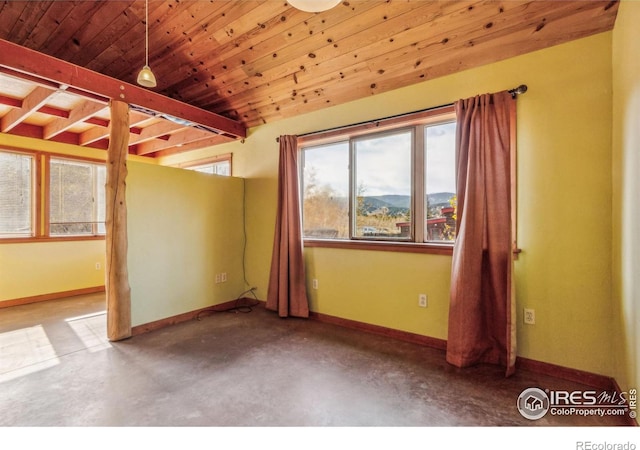 unfurnished room featuring a mountain view, wooden ceiling, and concrete flooring