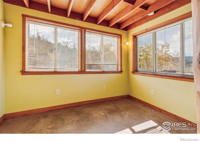 spare room with beam ceiling