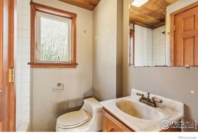 bathroom featuring vanity, toilet, and wood ceiling