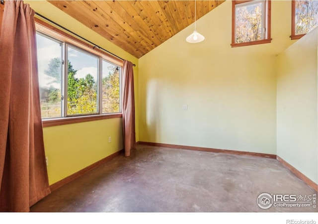 spare room featuring lofted ceiling, wooden ceiling, and concrete floors