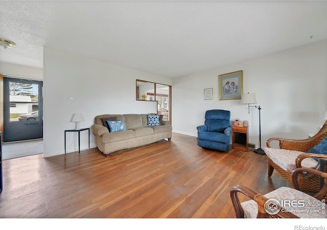 living room featuring hardwood / wood-style flooring and a textured ceiling