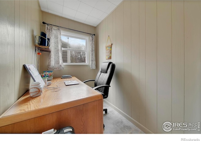 office area featuring wood walls