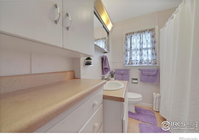 bathroom featuring toilet and vanity