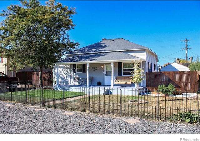 bungalow-style house featuring a front lawn and covered porch