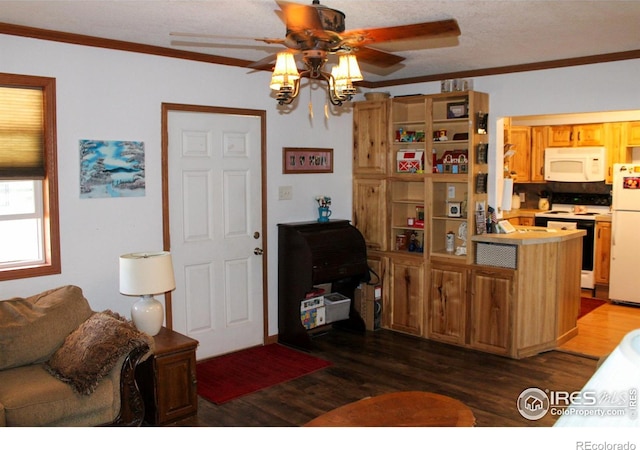 kitchen featuring crown molding, dark hardwood / wood-style floors, white appliances, and ceiling fan