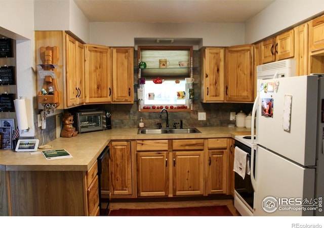 kitchen featuring white appliances, decorative backsplash, and sink