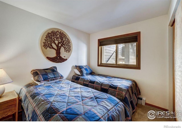 carpeted bedroom featuring baseboard heating