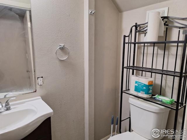 bathroom with vanity and toilet