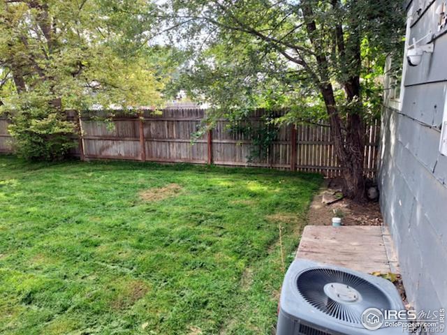 view of yard featuring central air condition unit