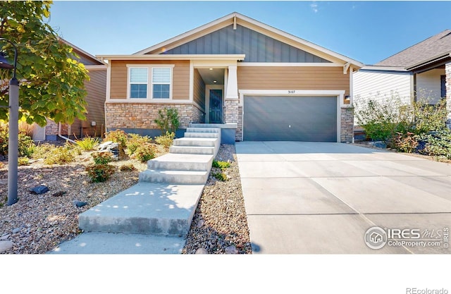 3107 Deering Lake Dr, Loveland, CO 80538 - craftsman-style house with a garage, stone siding, concrete driveway, and board and batten siding