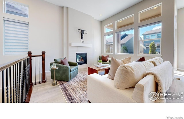 3107 Deering Lake Dr, Loveland, CO 80538 - living room with baseboards, wood finished floors, and a fireplace