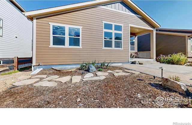 3107 Deering Lake Dr, Loveland, CO 80538 - rear view of property with fence and board and batten siding