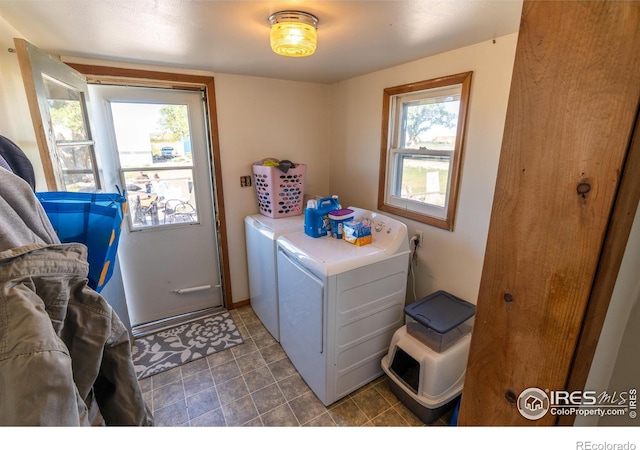 washroom featuring washing machine and clothes dryer and a wealth of natural light