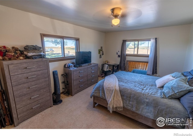 bedroom featuring ceiling fan and light colored carpet