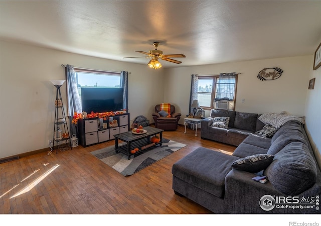 17327 County Road 46, Sterling, CO 80751 - living area featuring hardwood / wood-style flooring, ceiling fan, baseboards, and cooling unit